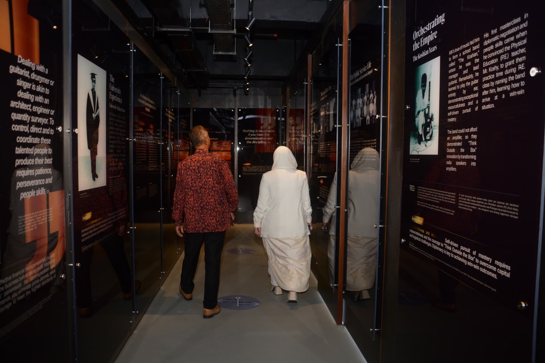 Guests walking through the Yayasan EMKAY anniversary exhibition