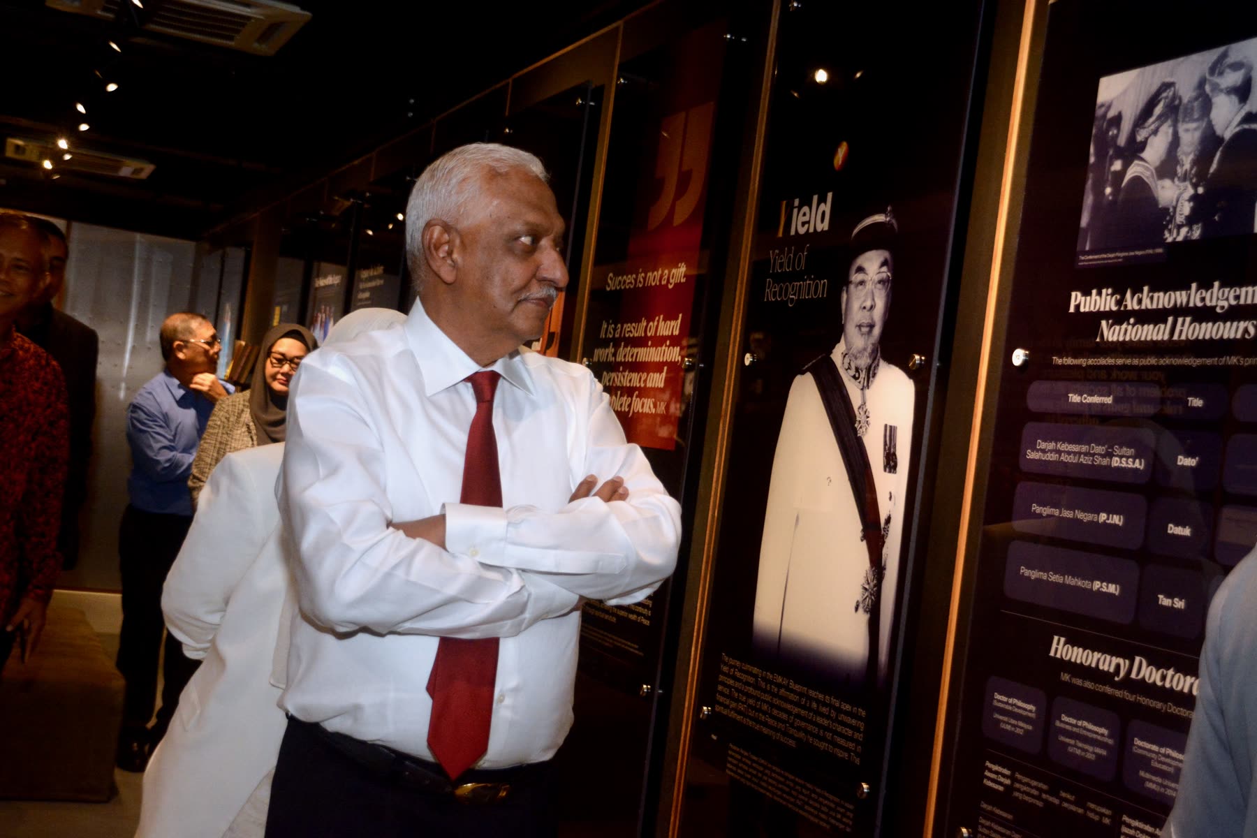 A guest viewing the Yayasan EMKAY exhibition