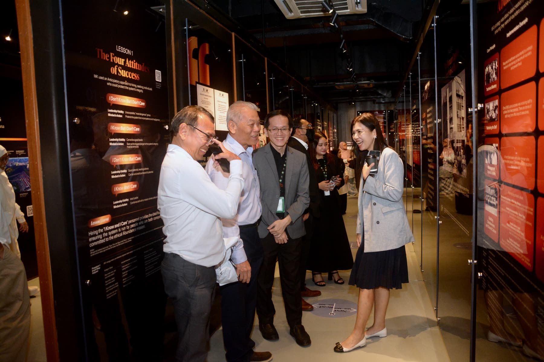 Guests sharing a light moment inside the Yayasan EMKAY exhibition