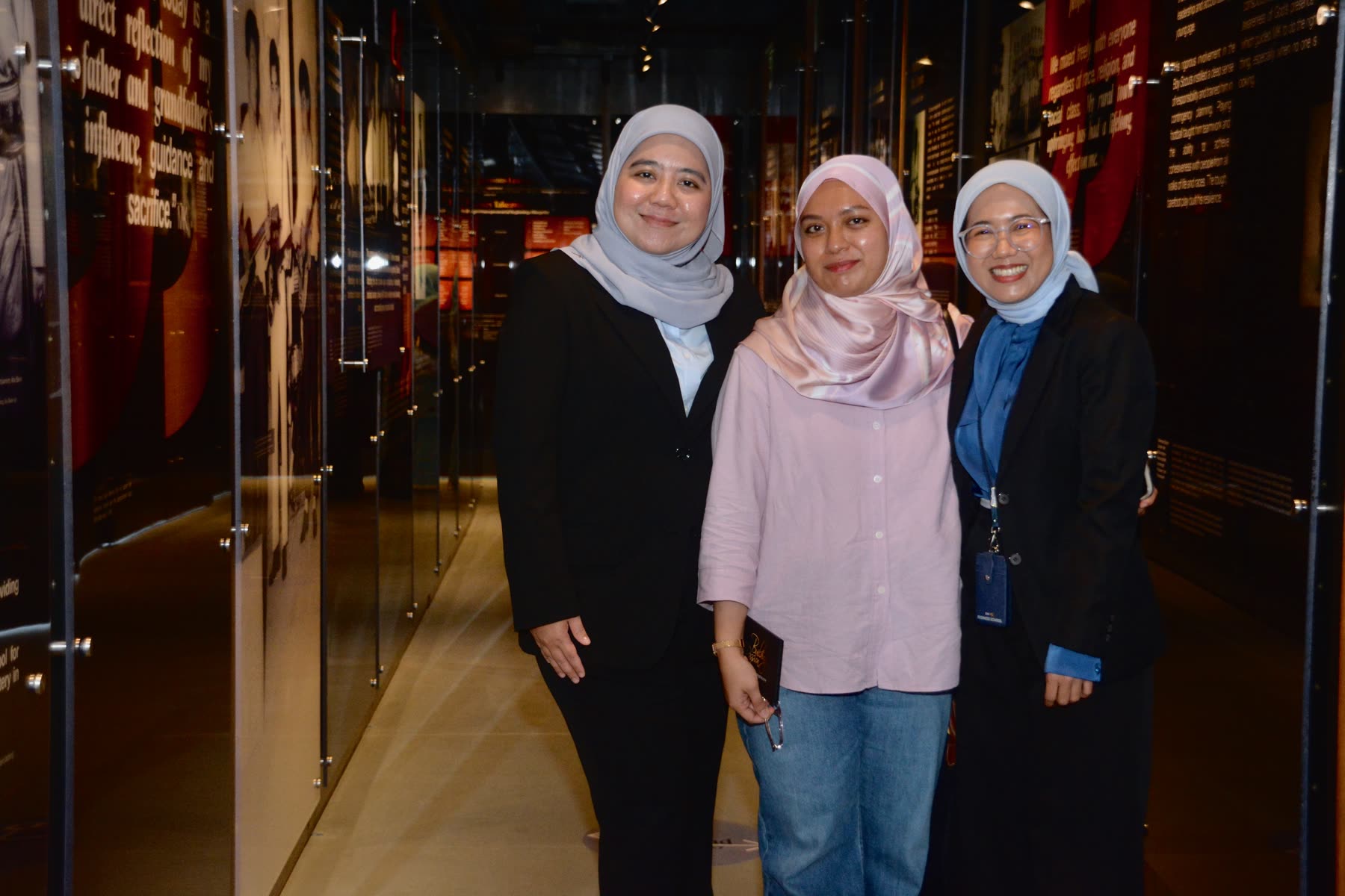 Three guests photographed at the Yayasan EMKAY 25th anniversary